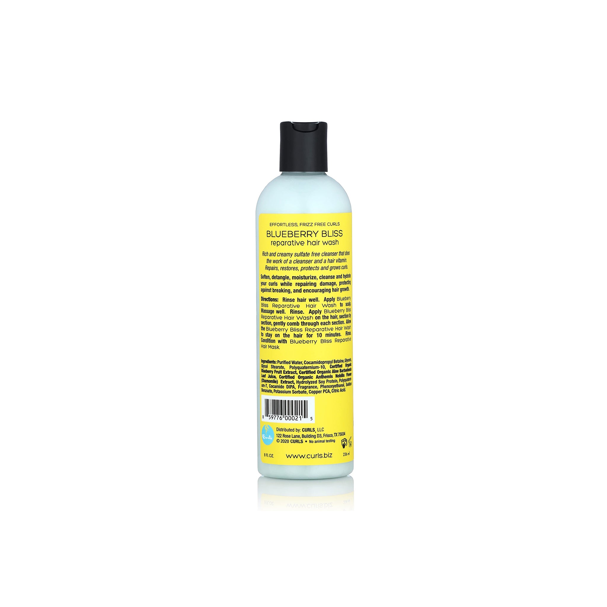 Reparativ hårvask Curls Blueberry Bliss i en lyseblå flaske med sort låg og gul etiket, der beskriver produktets ingredienser og egenskaber.