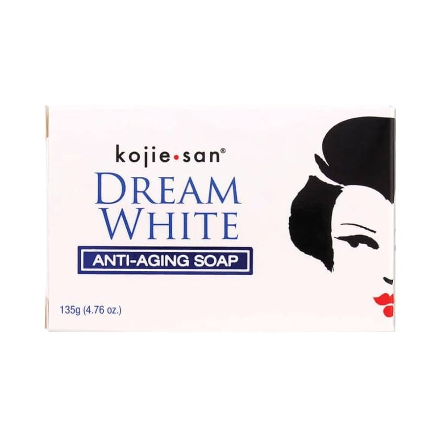 Hvid æske med Kojie San Dream White anti-aging soap, dekoreret med sort-hvid kvindeillustration og blå tekst.
