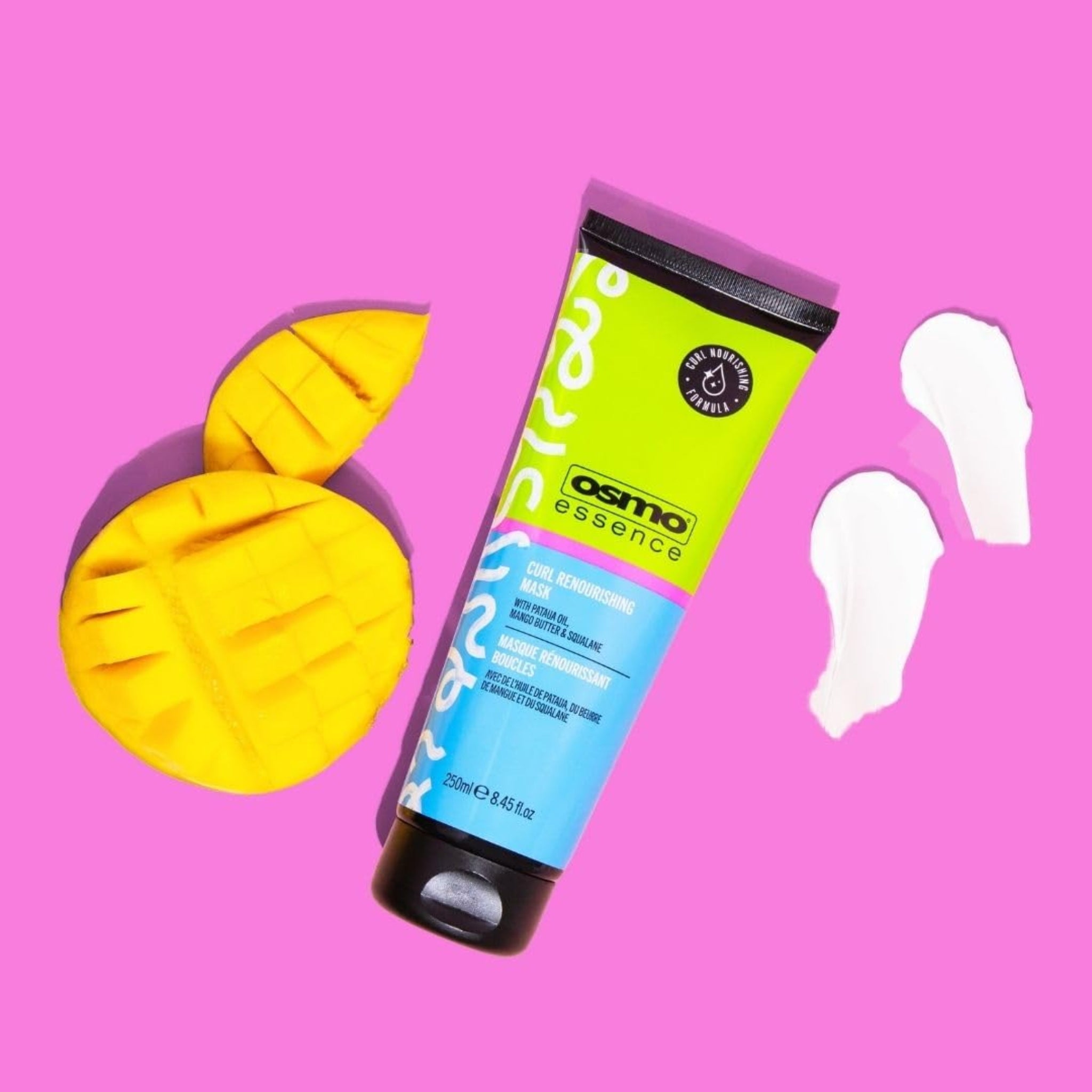 OSMO Essence Curl Renourishing Mask tube på lyserød baggrund med skåret mango og cremede tekstur-strøg.