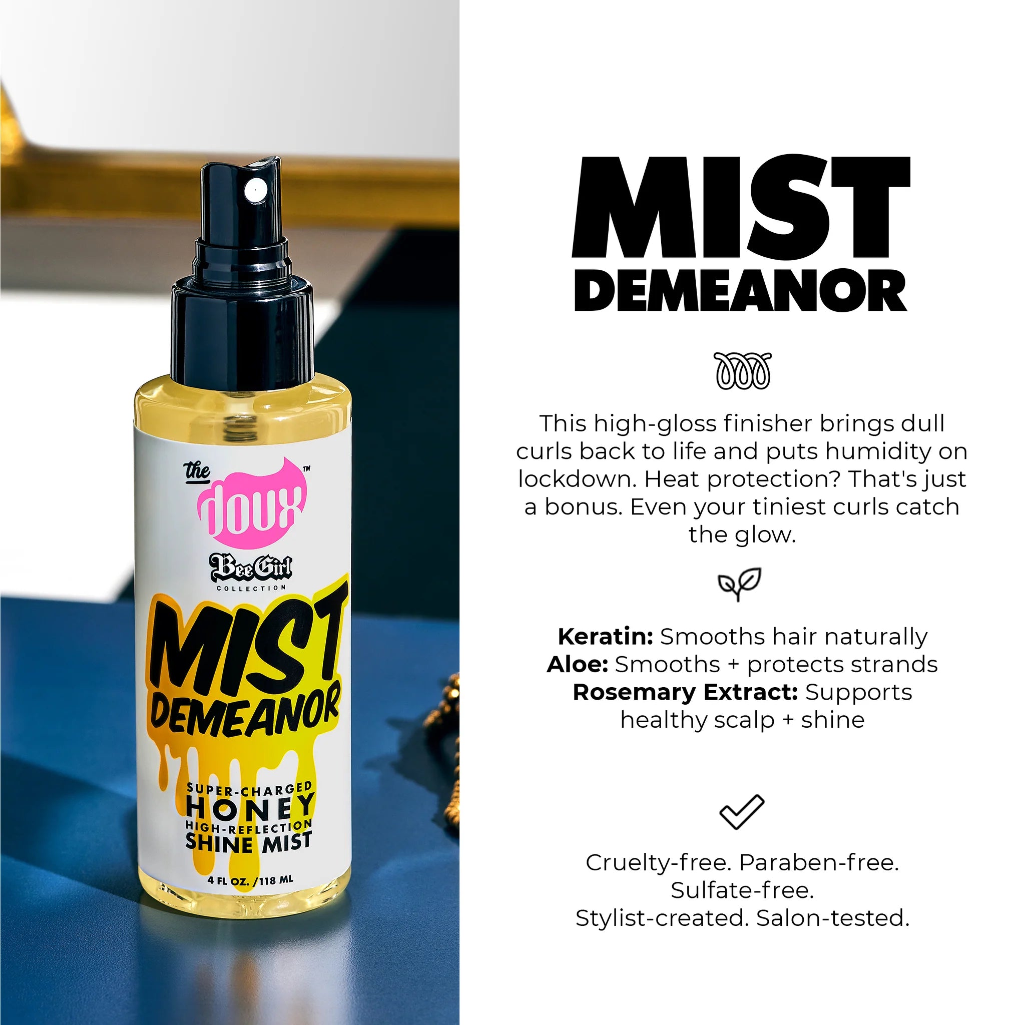 The Doux Bee Girl Mist Demeanor honning shine mist spraysprøjteflaske på blåt bord med gyldent glansfinish.